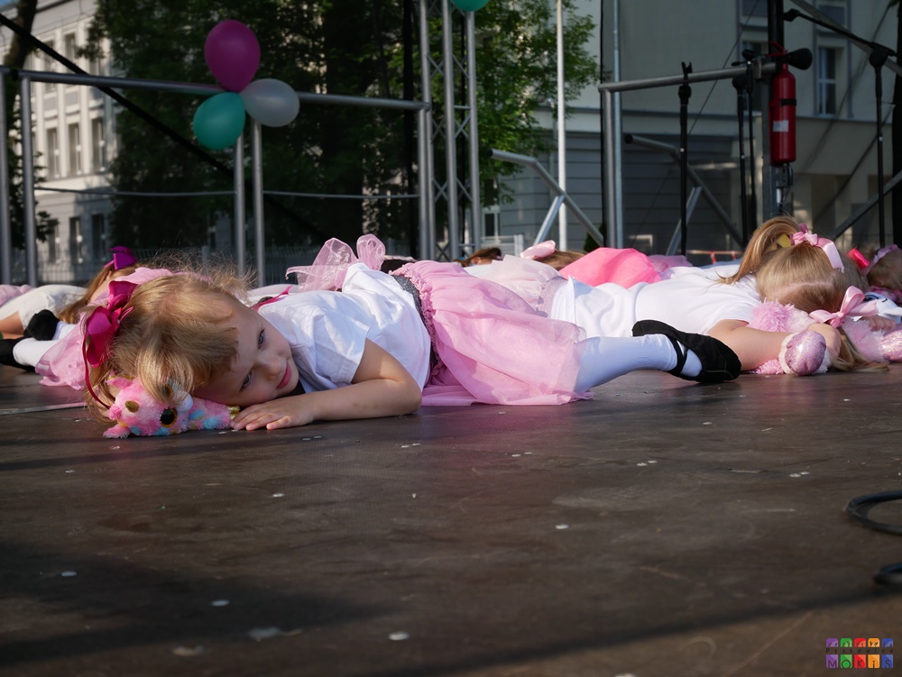 Zdjęcie przedstawiające tańczące dzieci i młodzież na scenie w trakcie festynu.
