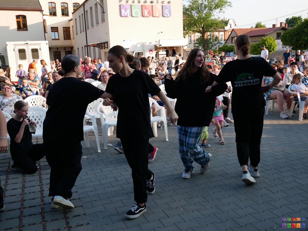 Zdjęcie przedstawiające tańczącą młodzież i dzieci w trakcie festynu na dziedzińcu MOKiS